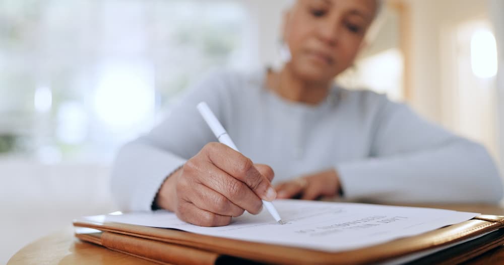 Person writing notes with white pen.