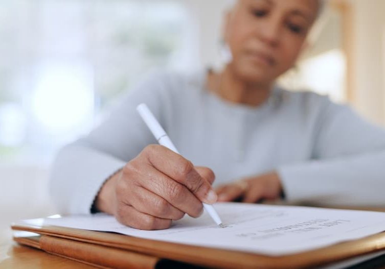 Person writing notes with white pen.